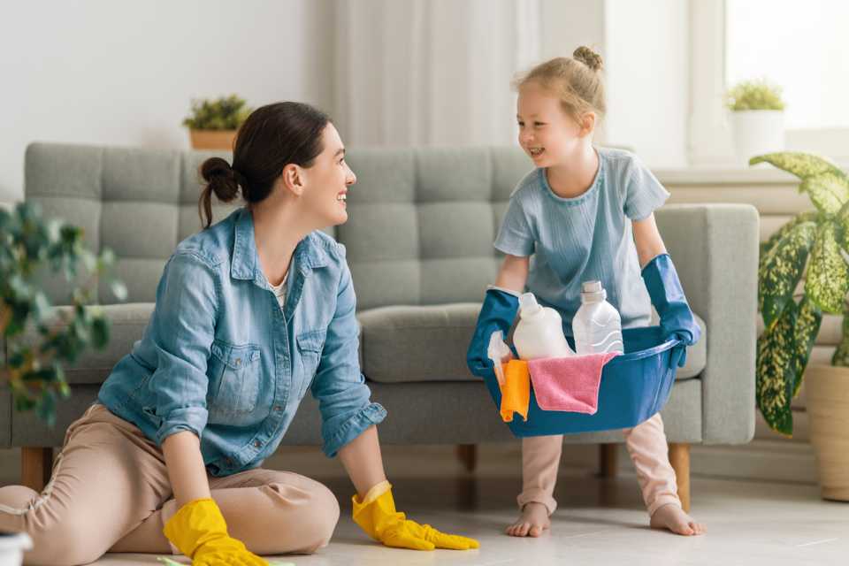 mom and little girl cleaning up their vinyl flooring in the living room 